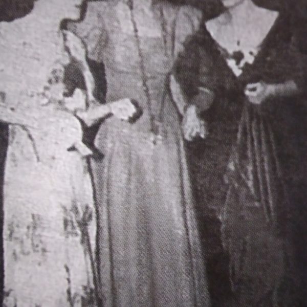 Two ladies in elegant Filipiniana flank an American friend at a formal Club event.